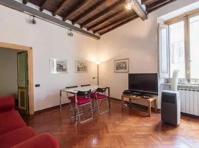 a living room with a couch and a table with chairs at Piazza Navona Charming Apartment in Rome