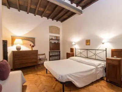 a bedroom with a bed and a table and a chair at Piazza Navona Charming Apartment in Rome