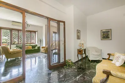 a living room with a large glass door to a living room at Rosso Levanto House in Rome