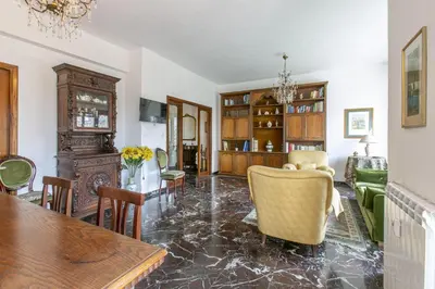 a living room with a dining room table and chairs at Rosso Levanto House in Rome