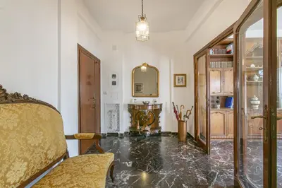 a living room with a marble floor and a mirror at Rosso Levanto House in Rome
