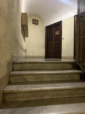a set of stairs leading to a wooden door at Hedi-Don sweet home-103 in Rome