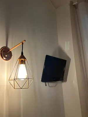 a lamp and a tv hanging on a wall at Hedi-Don sweet home-103 in Rome