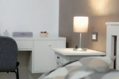 a bedroom with a desk and a bed with a lamp at A casa di Pina - Roma St Peter in Rome
