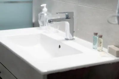 a bathroom sink with a faucet and toothbrushes at A casa di Pina - Roma St Peter in Rome