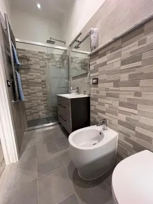 a bathroom with a white toilet and a sink at A casa di Pina - Roma St Peter in Rome