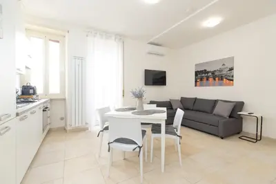 a kitchen and living room with a table and a couch at Casa Luna in Rome