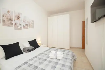 a bedroom with a bed and a tv on a wall at Casa Luna in Rome