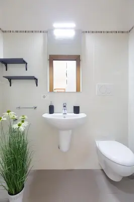 a white bathroom with a sink and a toilet at Casa Luna in Rome