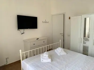 a bedroom with a bed and a tv on the wall at Vaticano Apartment in Rome