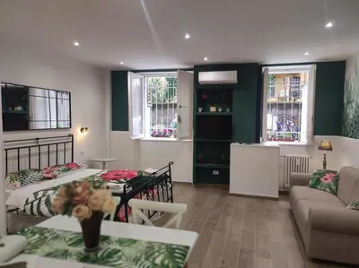 a living room with a bed and a couch at Sweet Rome Holiday Flaminio-The biggest shower in Rome