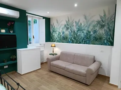 a living room with a couch and a painting on the wall at Sweet Rome Holiday Flaminio-The biggest shower in Rome
