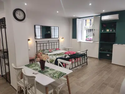 a dining room with two tables and a clock on the wall at Sweet Rome Holiday Flaminio-The biggest shower in Rome