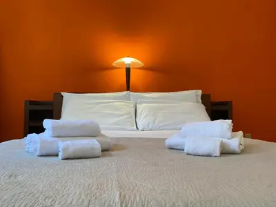 a bed with two piles of towels on it at Idi's House in Rome