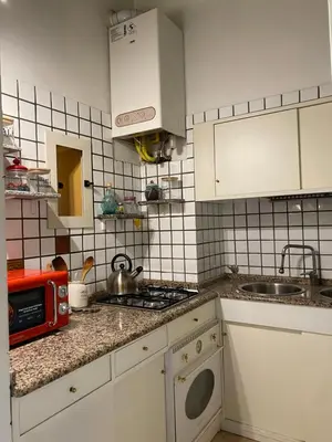 a kitchen with a sink and a stove top oven at Idi's House in Rome