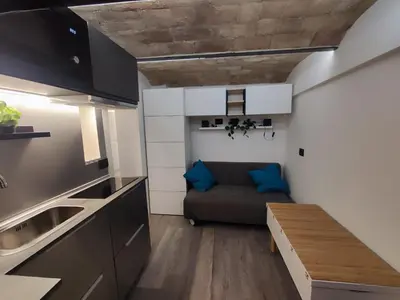 a small kitchen with a couch in a room at RomAmoR Spagna in Rome