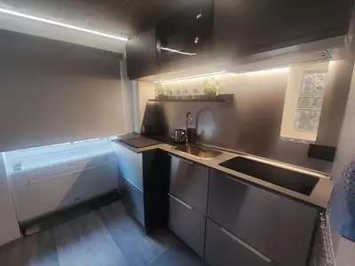 a small kitchen with a sink and a stove at RomAmoR Spagna in Rome
