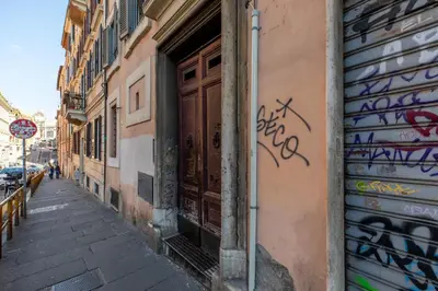 a street with graffiti on the side of a building at iFlat Bright Brand New 3-Bedroom Apt in Monti in Rome