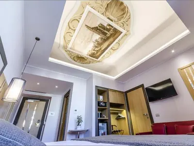 a ceiling with a painting on it in a bedroom at Vibe Nazionale in Rome