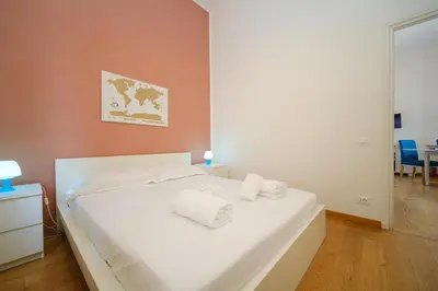a bedroom with a white bed with two towels on it at Clivo 2 St Peter BuddyRent in Rome