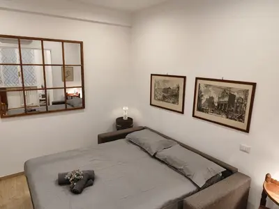 a bedroom with a bed and two pictures on the wall at A&B Vatican Domus in Rome