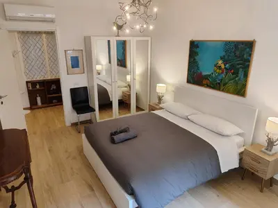 a bedroom with a large bed and a mirror at A&B Vatican Domus in Rome