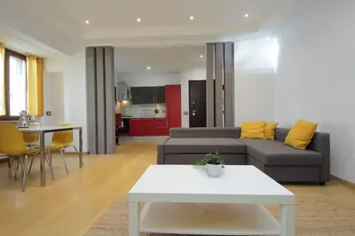 a living room with a couch and a table at Cozy and comfy apartment in Piramide metro stop in Rome