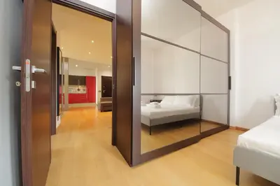 a bedroom with a bed and a large mirror at Cozy and comfy apartment in Piramide metro stop in Rome