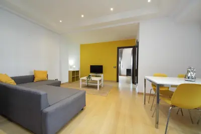a living room with a couch and a table at Cozy and comfy apartment in Piramide metro stop in Rome