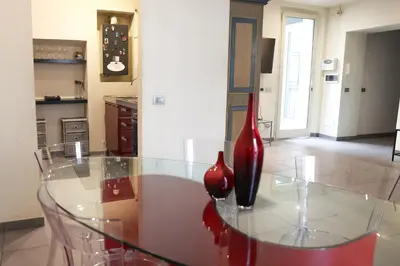 a glass table with two vases sitting on top of it at Domus Superior Domizio - Pantheon in Rome