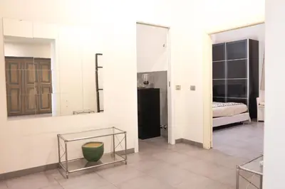 a room with a bed and a table and a mirror at Domus Superior Domizio - Pantheon in Rome