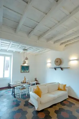 a living room with a white couch and a table at Domus Superior Domizio - Pantheon in Rome