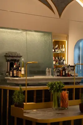 a bar with a counter with bottles of alcohol at Maison Roma Piazza di Spagna UNA Esperienze in Rome