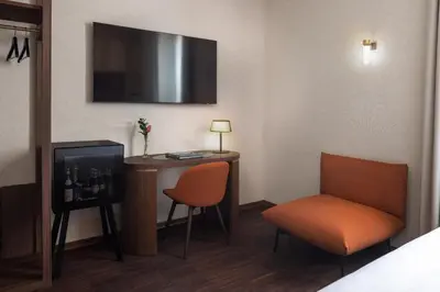 a room with a desk and a chair and a tv at Maison Roma Piazza di Spagna UNA Esperienze in Rome