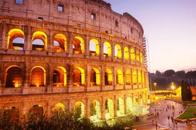 a large building with yellow lights on it at Voluptas House Termini San Lorenzo in Rome