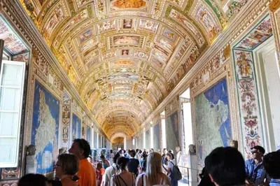 a crowd of people in a large room with paintings on the walls at Voluptas House Termini San Lorenzo in Rome