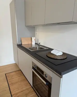 a kitchen with a sink and a counter top at Voluptas House Termini San Lorenzo in Rome