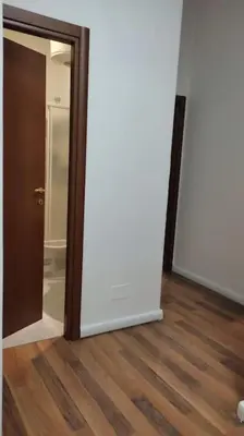 an empty room with a door and a wooden floor at Gianicolo House in Rome