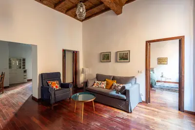 a living room with a couch and a table at Trastevere Lungaretta apartment in Rome