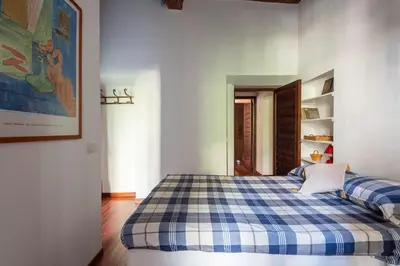 a bedroom with a blue and white checkered bed at Trastevere Lungaretta apartment in Rome