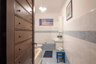 a bathroom with a sink and a toilet and a tub at Trastevere Lungaretta apartment in Rome