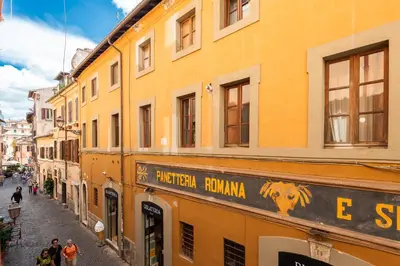 a building with a sign on the side of a street at Trastevere Lungaretta apartment in Rome