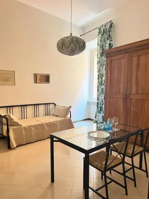 a living room with a table and a couch at Suite in appartamento in Rome