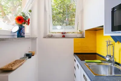 a kitchen with a sink and a window at Charming restored loft in the heart of Trastevere in Rome