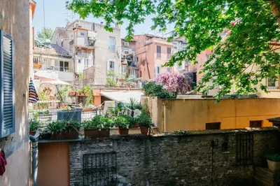 a view of a city with buildings and plants at Charming restored loft in the heart of Trastevere in Rome