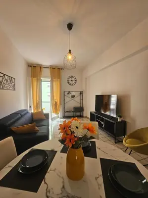 a living room with a vase with flowers on a table at R home of art in Rome