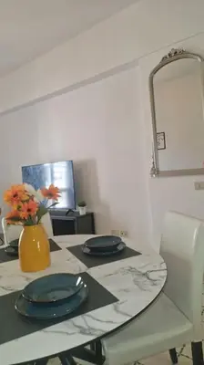 a table with two blue plates and a vase with flowers at R home of art in Rome