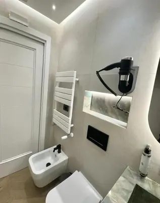 a white bathroom with a sink and a toilet at Roma Luxury Stay 56 in Rome