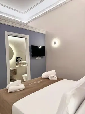 a bedroom with a bed with two towels on it at Roma Luxury Stay 56 in Rome