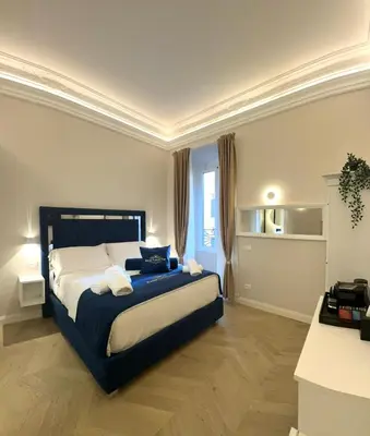 a bedroom with a large bed with a blue blanket at Roma Luxury Stay 56 in Rome